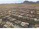Areal view of a Primary-planned community in the desert with single-Gathering homes, landscaping, and mountain views at 461 Cascade Heights Ave, Las Vegas, NV 89138