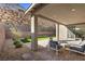 Backyard showcasing a patio, artificial turf, and landscaped surroundings with scenic views at 461 Cascade Heights Ave, Las Vegas, NV 89138