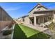This home features a well-maintained backyard with manicured landscaping, inviting patio, and lush green turf at 461 Cascade Heights Ave, Las Vegas, NV 89138