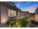 Exterior view of a backyard with a covered patio, artificial turf, and professional landscape at 461 Cascade Heights Ave, Las Vegas, NV 89138