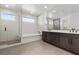 Bright bathroom featuring double sink vanity, modern tile, walk-in shower and tub at 461 Cascade Heights Ave, Las Vegas, NV 89138