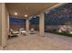 Inviting covered patio with brick pavers, sleek outdoor furniture, and landscape views at 461 Cascade Heights Ave, Las Vegas, NV 89138
