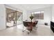 Sunlit dining area with a modern table and chairs, leading to an outdoor patio through sliding glass doors at 461 Cascade Heights Ave, Las Vegas, NV 89138