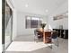 Dining space with a modern table set, bright lighting, and seamless access to the outdoor space at 461 Cascade Heights Ave, Las Vegas, NV 89138