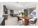 Bright open-concept dining room featuring a modern table, chairs, and sliding glass doors to the patio at 461 Cascade Heights Ave, Las Vegas, NV 89138