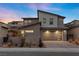 Contemporary two-story home featuring desert landscaping, modern garage door, and neutral color palette at 461 Cascade Heights Ave, Las Vegas, NV 89138