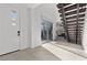 Bright foyer featuring tile floors, glass sliding doors, and staircase with modern railings at 461 Cascade Heights Ave, Las Vegas, NV 89138