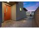 Inviting front entrance featuring a modern orange door with decorative windows and a well-lit walkway at 461 Cascade Heights Ave, Las Vegas, NV 89138