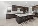 Modern kitchen with a large island, dark cabinets, and stainless steel appliances at 461 Cascade Heights Ave, Las Vegas, NV 89138