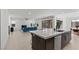 Open-concept kitchen and living room area with tile floors and an eat-in kitchen island at 461 Cascade Heights Ave, Las Vegas, NV 89138