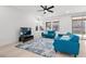Bright living room featuring a ceiling fan, modern furniture, a decorative rug, and plenty of natural light at 461 Cascade Heights Ave, Las Vegas, NV 89138