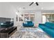 Bright and airy living room with large windows, hardwood floors, and comfortable seating arrangements at 461 Cascade Heights Ave, Las Vegas, NV 89138