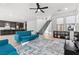 Open-concept living area with tile floors, a view of staircase, and furniture placed over a large rug at 461 Cascade Heights Ave, Las Vegas, NV 89138