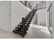 Open-concept home showcasing a floating staircase with dark wood and a bright, spacious entryway at 461 Cascade Heights Ave, Las Vegas, NV 89138
