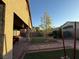 The backyard featuring an outdoor seating area and landscaping with gravel and pavers at 4837 Skyraider St, North Las Vegas, NV 89031