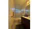 Well-lit bathroom with a shower-tub combination, dark wood cabinets, and modern fixtures at 4837 Skyraider St, North Las Vegas, NV 89031