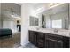 Bathroom featuring double sinks, a vanity with dark wood cabinets, and tile floors at 4837 Skyraider St, North Las Vegas, NV 89031