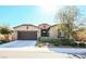 Charming single-story home featuring a well-manicured lawn and a two-car garage at 4837 Skyraider St, North Las Vegas, NV 89031
