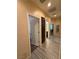 Hallway with tile flooring, neutral walls, and views into other rooms at 4837 Skyraider St, North Las Vegas, NV 89031
