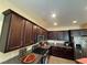 Modern kitchen featuring dark cabinetry, stainless steel appliances, and granite countertops at 4837 Skyraider St, North Las Vegas, NV 89031