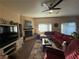 Cozy living room with ceiling fan, fireplace, and sliding door access to the backyard at 4837 Skyraider St, North Las Vegas, NV 89031