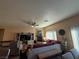 Spacious living room featuring neutral furniture, fireplace, and ample natural light at 4837 Skyraider St, North Las Vegas, NV 89031
