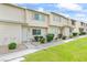 Inviting townhouse with green lawn, sidewalk, and landscaped garden beds at 4920 Larkspur St, Las Vegas, NV 89120