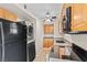 Close-up shot of the kitchen featuring a washing machine, modern appliances, and tile flooring at 4920 Larkspur St, Las Vegas, NV 89120