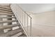 Carpeted staircase with white railing leading to the upper level of the home at 4920 Larkspur St, Las Vegas, NV 89120