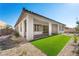 This home's backyard boasts synthetic grass, gravel landscaping and a covered patio at 50 Barrio Alto Ct, Henderson, NV 89011
