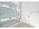 Bright bathroom featuring glass enclosed shower and stone tile at 50 Barrio Alto Ct, Henderson, NV 89011
