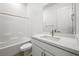 Modern bathroom with white tub, vanity, and bright white quartz countertop at 50 Barrio Alto Ct, Henderson, NV 89011