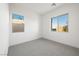 Well-lit bedroom with carpet, neutral walls, and modern double hung windows at 50 Barrio Alto Ct, Henderson, NV 89011