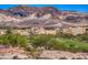Scenic community featuring colorful buildings, green lawns and a mountain backdrop at 50 Barrio Alto Ct, Henderson, NV 89011