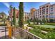 Well-manicured courtyard with symmetrical hedges, vibrant flowers, and charming architecture at 50 Barrio Alto Ct, Henderson, NV 89011