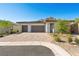 Charming single-story home with stone accents, a three-car garage and desert landscaping at 50 Barrio Alto Ct, Henderson, NV 89011