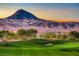 Picturesque golf course with rolling green hills, sand traps, and stunning mountain scenery at dusk at 50 Barrio Alto Ct, Henderson, NV 89011