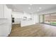 Modern kitchen with white cabinets, stainless steel appliances, a large island, and sliding glass doors at 50 Barrio Alto Ct, Henderson, NV 89011