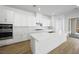 Well-equipped kitchen featuring a large island, sleek white cabinets, and stainless steel appliances at 50 Barrio Alto Ct, Henderson, NV 89011