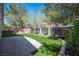 Backyard featuring mature landscaping, artificial turf, hardscape patio, and a hot tub at 5000 Charlo Dr, Las Vegas, NV 89131