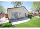 Home backyard featuring mature landscaping, artificial turf, hardscape patio, and a hot tub at 5000 Charlo Dr, Las Vegas, NV 89131