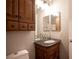 Bathroom vanity featuring a granite countertop and warm wood cabinetry, well lit with neutral paint at 5000 Charlo Dr, Las Vegas, NV 89131