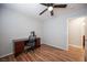 Bedroom featuring wood flooring, ceiling fan, and a wooden desk that faces the doorway at 5000 Charlo Dr, Las Vegas, NV 89131