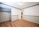 Bedroom featuring wood floors, white walls, a walk-in closet, and an en suite bathroom at 5000 Charlo Dr, Las Vegas, NV 89131