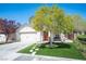 Charming single-story home with a well-manicured lawn, stone path, and a two car garage at 5000 Charlo Dr, Las Vegas, NV 89131