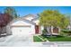 Charming single-story home with a well-manicured lawn and a two car garage at 5000 Charlo Dr, Las Vegas, NV 89131