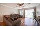 Comfortable living room featuring a large sectional couch, wood floors, and great natural light at 5000 Charlo Dr, Las Vegas, NV 89131