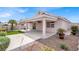 Expansive backyard with covered patio, low-maintenance desert landscaping, and artificial turf at 5244 Velazco Ln, Las Vegas, NV 89130