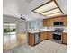 Modern kitchen with stainless appliances, bar seating, and sliding glass doors to the yard at 5244 Velazco Ln, Las Vegas, NV 89130