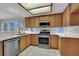 Well-lit kitchen with wooden cabinets, stainless steel appliances, and white countertops at 5244 Velazco Ln, Las Vegas, NV 89130